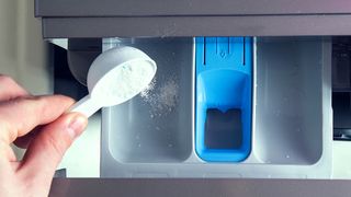 A detergent drawer of a washing machine with powder detergent being added