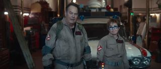 Dan Aykroyd and Annie Potts stand together in uniform in Ghostbusters: Frozen Empire.