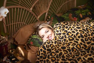 Rosie Molloy has given up everything except snuggling under a leopard print duvet.