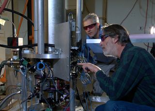 NIST physicists Steve Jefferts (foreground) and Tom Heavner with the NIST-F2 cesium fountain atomic clock.