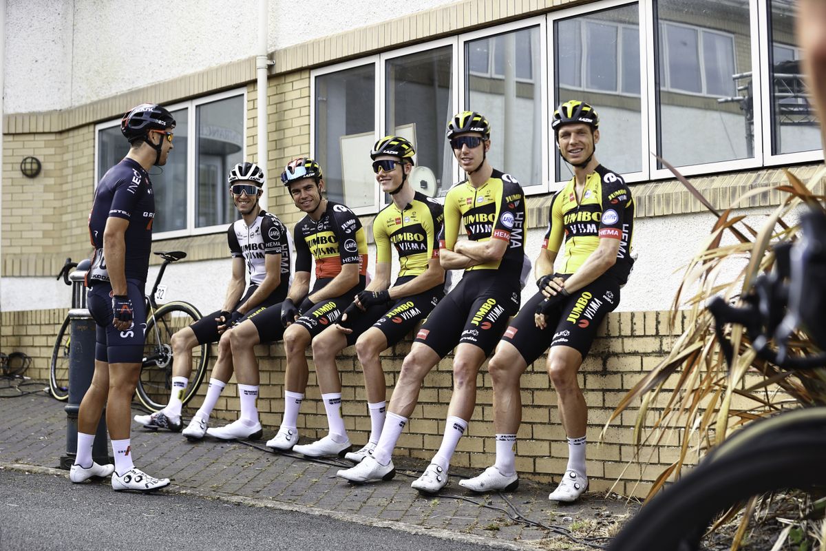 Picture by SWpix.com - 08/09/2021 - Cycling - AJ Bell Tour of Britain Stage 4 - Aberaeron to Great Orme, Llandudno, England - Team Jumbo Visma sit on a wall as they wait for Stage 4 to begin.
