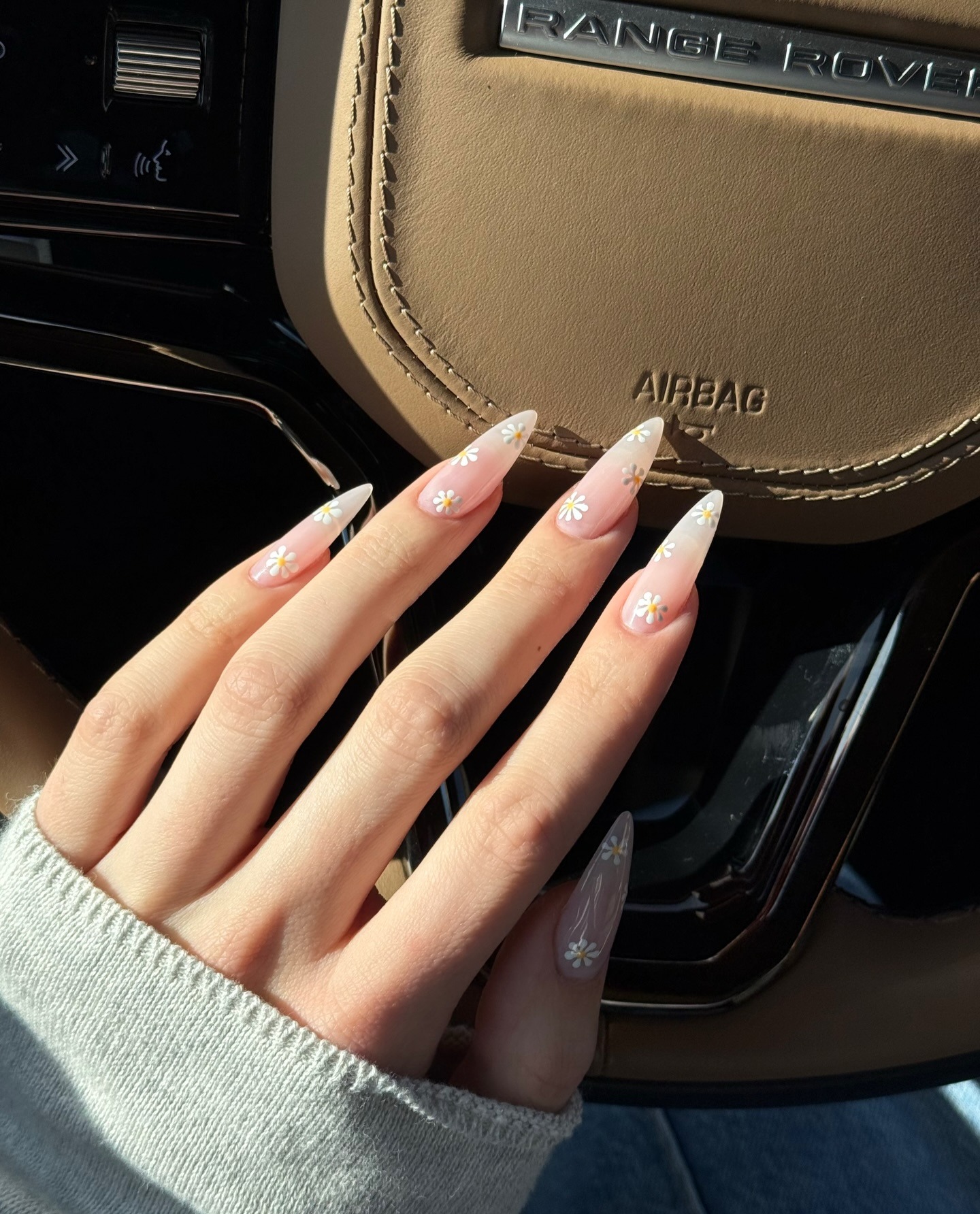A clear nail design with daisy detailing
