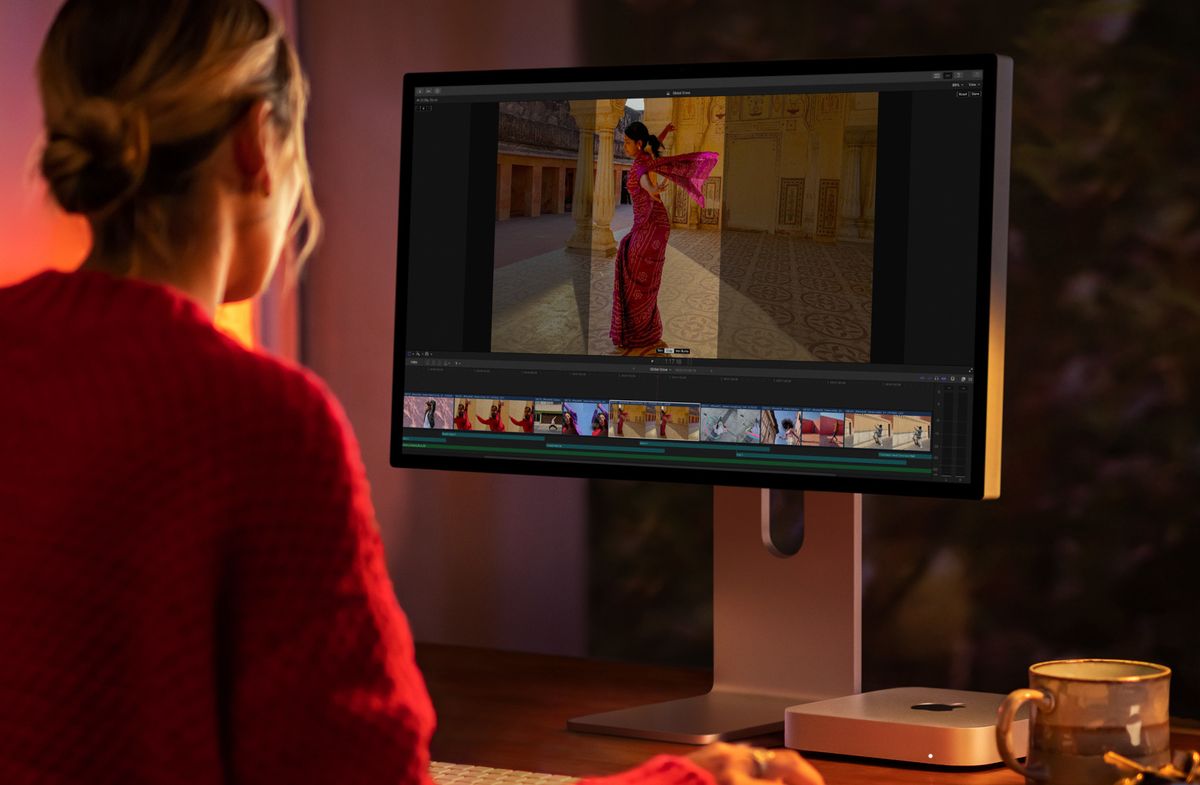 Mac Mini powered by M2 on a desktop paired to Apple Studio Display