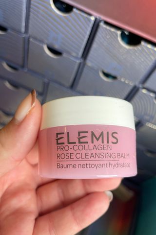 Valeza holding up the pro-collagen rose cleansing balm