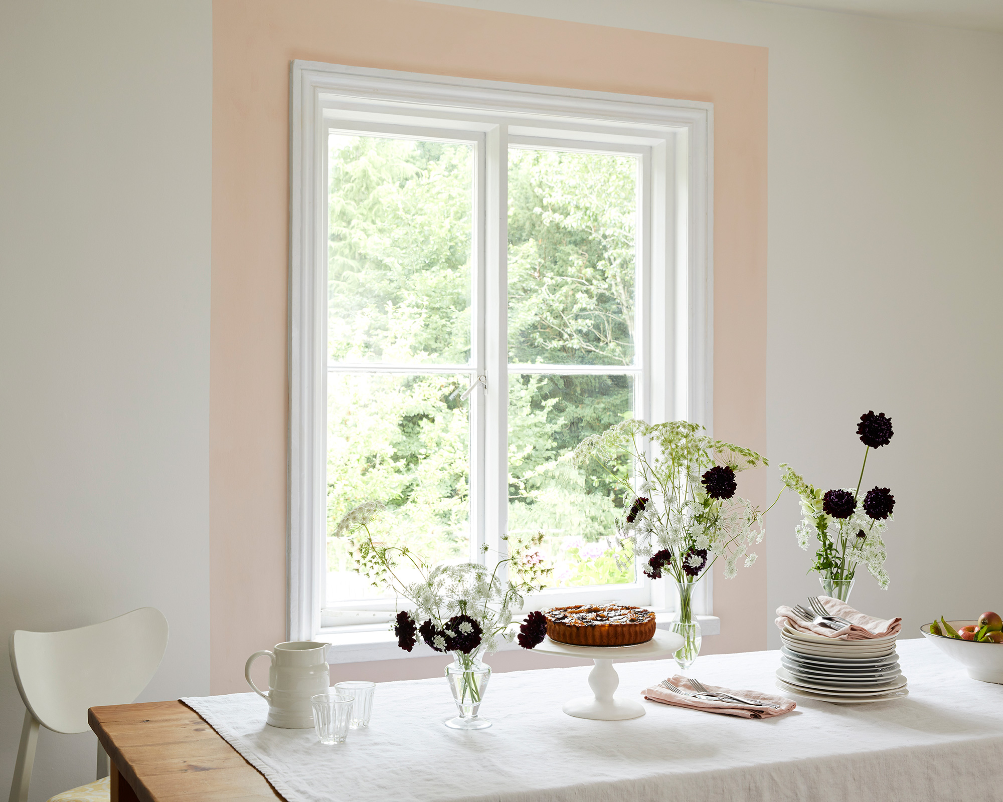 A small dining area with feature wall decor with long and thin table