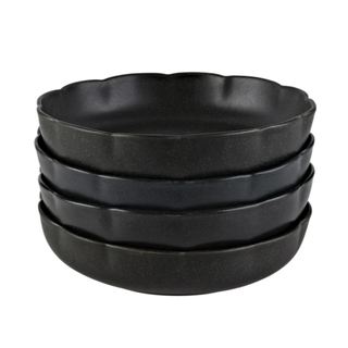 A stack of 4 black scalloped plates