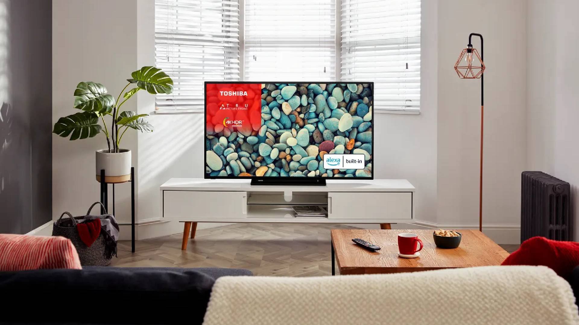 Toshiba UK31 TV on display in a living room surrounded by modern furniture