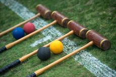 Croquet set laid out ready to play, croquet mallets and balls.Jayne Russell / Alamy Stock Photo