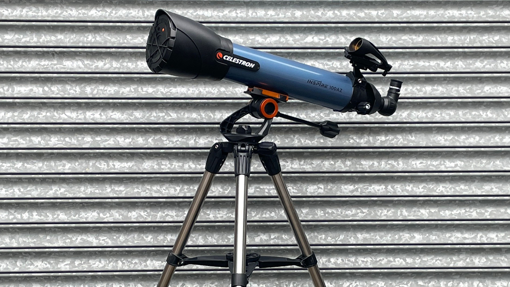 A side profile view of the telescope against a corrugated iron backdrop
