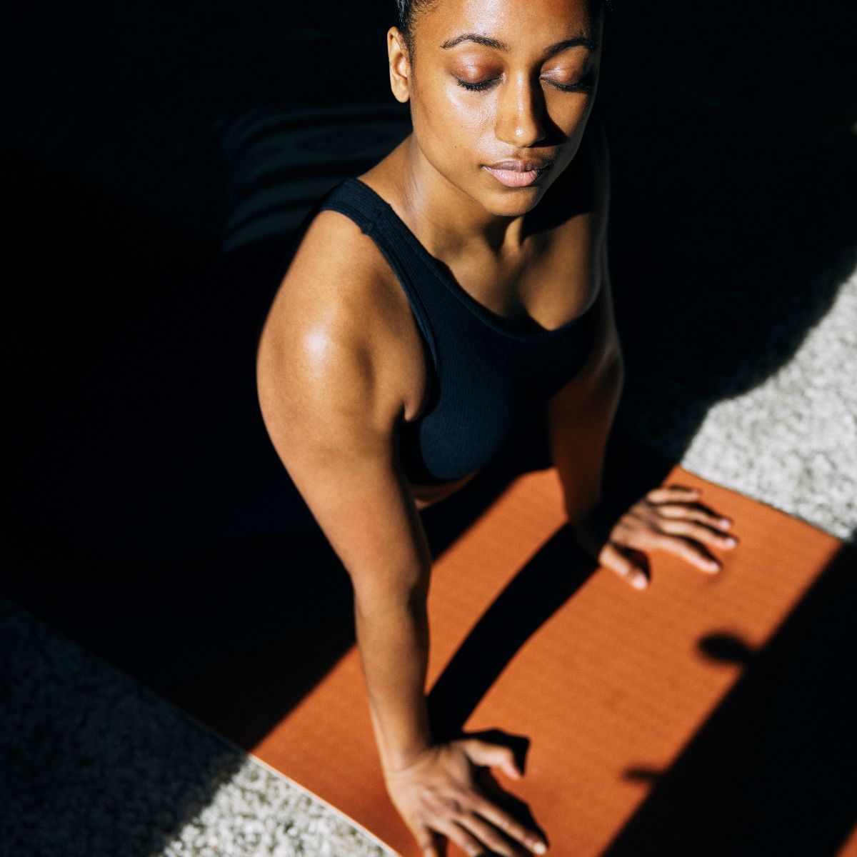 Best yoga mats - woman exercising on plain yoga mat