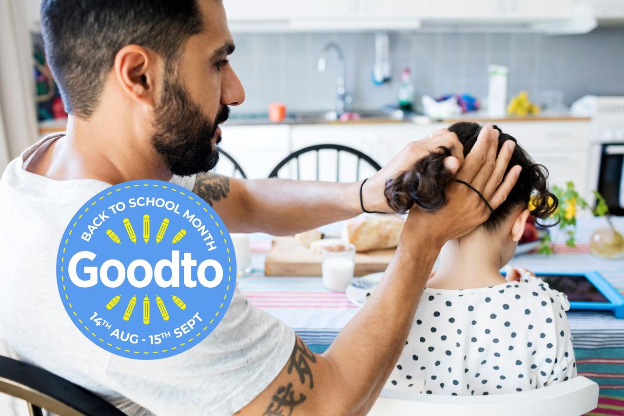 Hairstyle for school - a father is tying daughter&#039;s hair while sitting at table