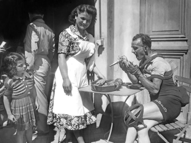 Frenchman Jean Robic enjoys a lobster before the start of the 4th stage of the Tour de France between Le Treport and Paris. Robic will finish 27th of the Tour de France, won by Swiss Hugo Koblet.