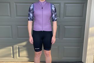 Woman cyclist wears Attaquer A-Line gilet, jersey and bib shorts