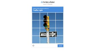 An image of a spoof ReCAPTCHA with text that reads "Select all the squares without a traffic light".