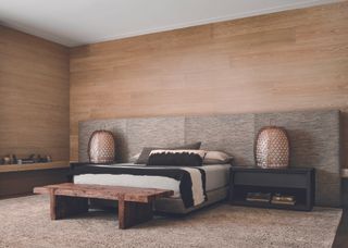 The main double bedroom uses wood paneling and a natural palette to ease relaxation