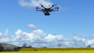 Drone photography: Image shows drone flying over yellow field