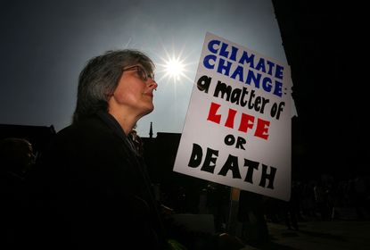 A protester with a sign about climate change
