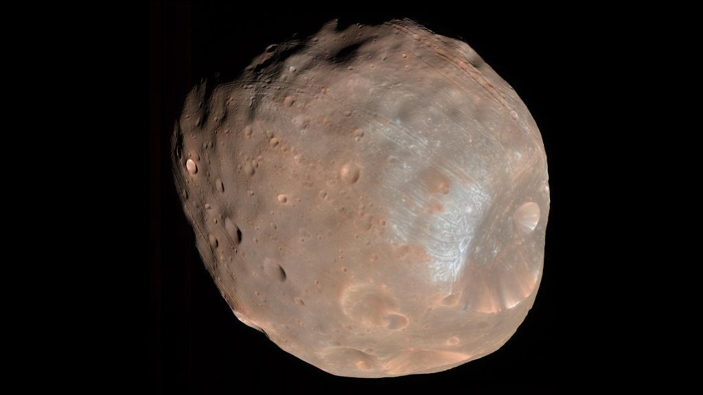 Mars&#039;s larger moon, Phobos, is a cratered, asteroid-like object.