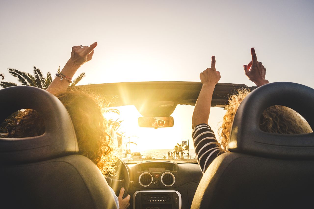 Women riding in a convertible.