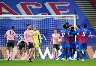 Sheffield United players react as Jeffrey Schlupp and Crystal Palace celebrate their first goal