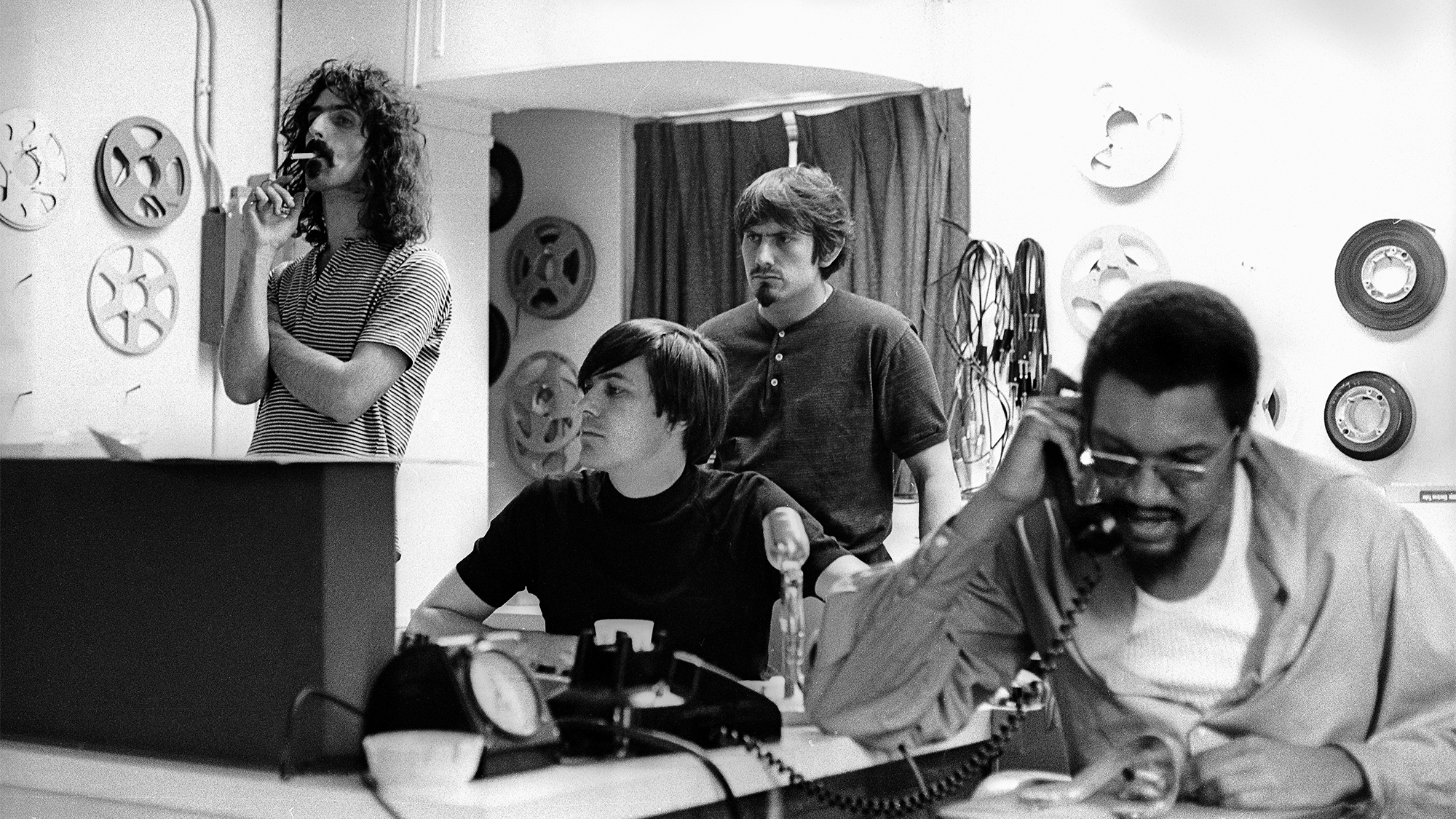 Frank Zappa listens as Mothers of Invention members record vocals at the Mayfair Recording Studio 701 7th Ave., NYC while recording the album &amp;quot;We're Only In It For The Money.&amp;quot; L-R Frank Zappa, recording engineer Gary Kellgren, bass player Roy Estrada, producer Tom Wilson.