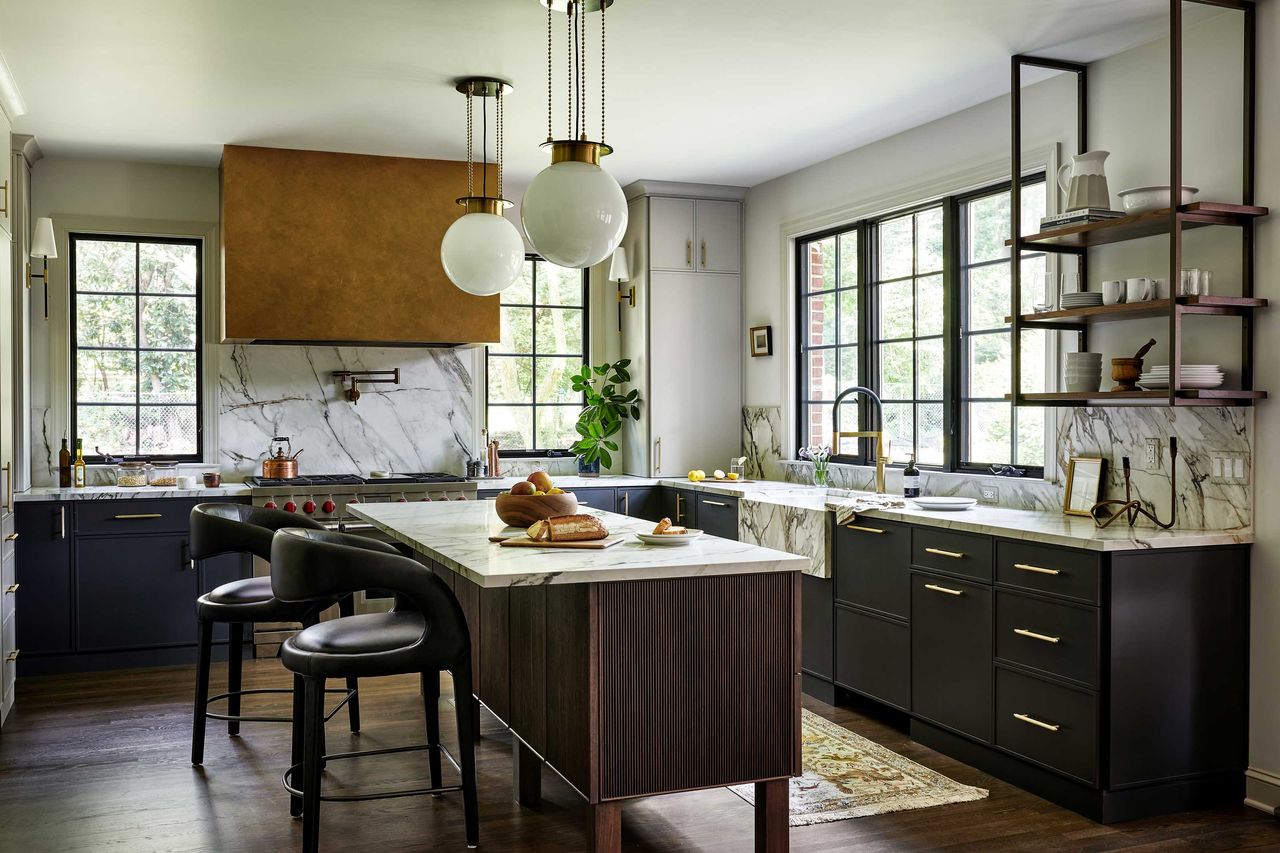 a modern kitchen with an island and dark cabinets