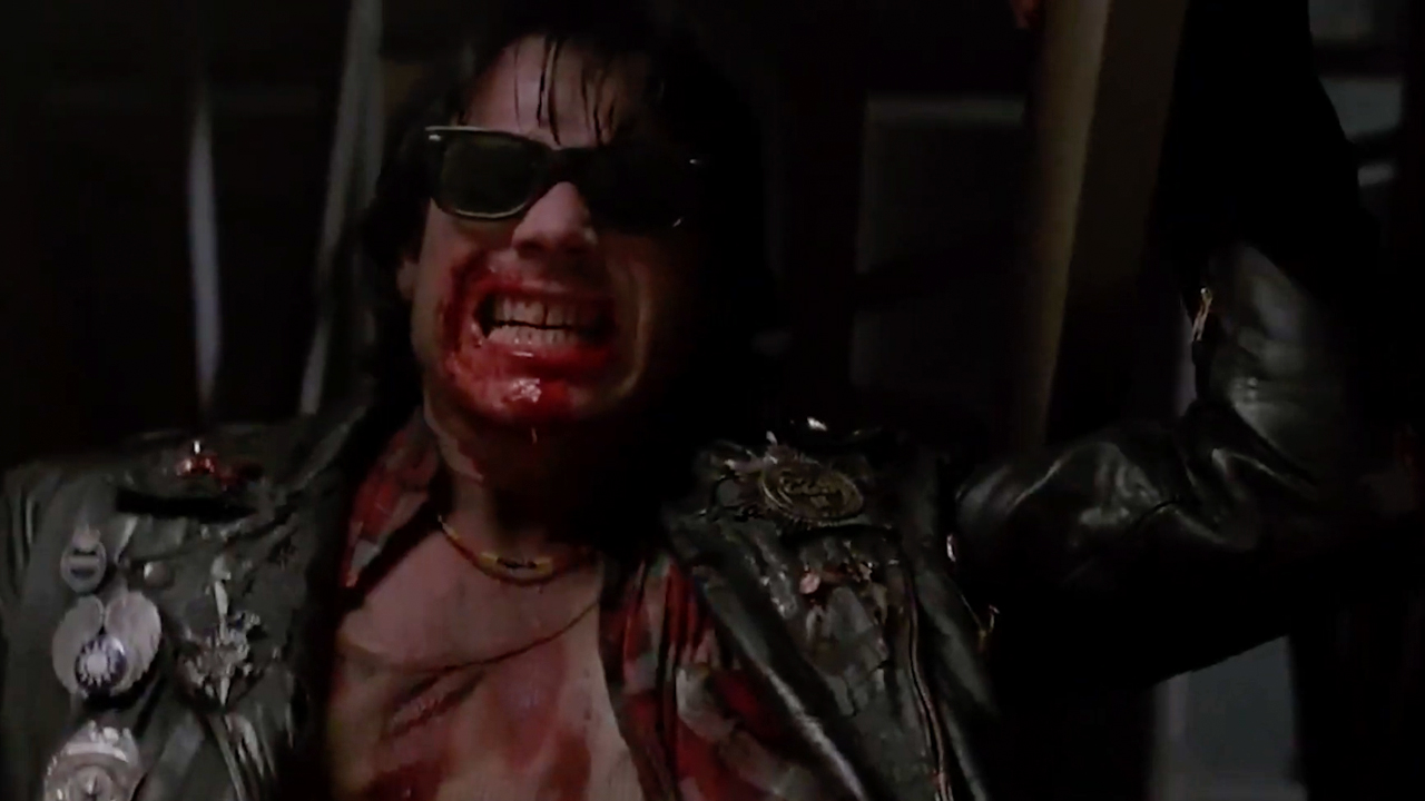 Bill Paxton is bloody and deadly, leaning back in his signature leather jacket and shades in Near Dark.