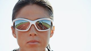 close up of female runner wearing sunglasses