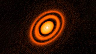 A false color view of the ring-like accretion disk around a young star named HD163296