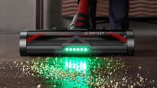 Ultenic U16 Flex vacuuming debris from wooden floor using green floorhead light