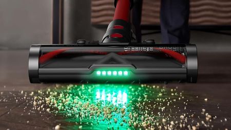 Ultenic U16 Flex vacuuming debris from wooden floor using green floorhead light