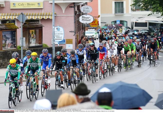 The peloton passes through small towns along the stage two route
