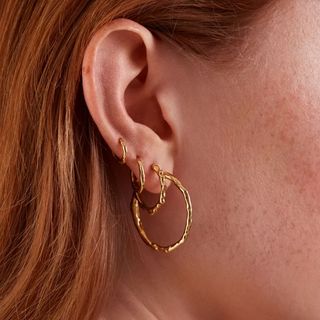 Close up of an ear with a Monica Vinader earring stack