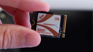 Sabrent Rocket Q4 2230 SSD in hand ready to be installed inside a Steam Deck.