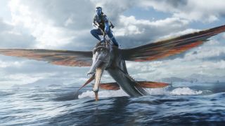 Jake rides a winged creature over the ocean in Avatar: The Way of Water.