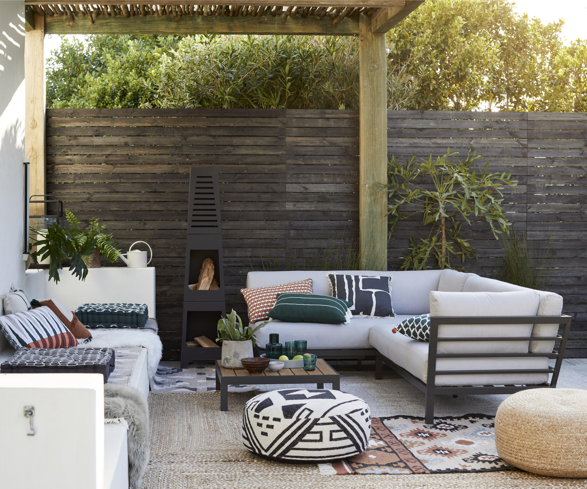 dark walnut slim horizontal fence panels with wooden pergola above patio with seating below