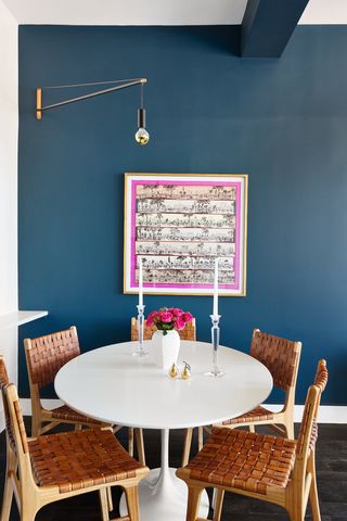 blue dining room with bold artwork by DATE Interiors
