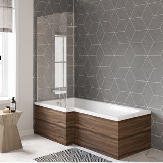 bathroom with grey hexagonal wall tiles and dark wooden bath panel