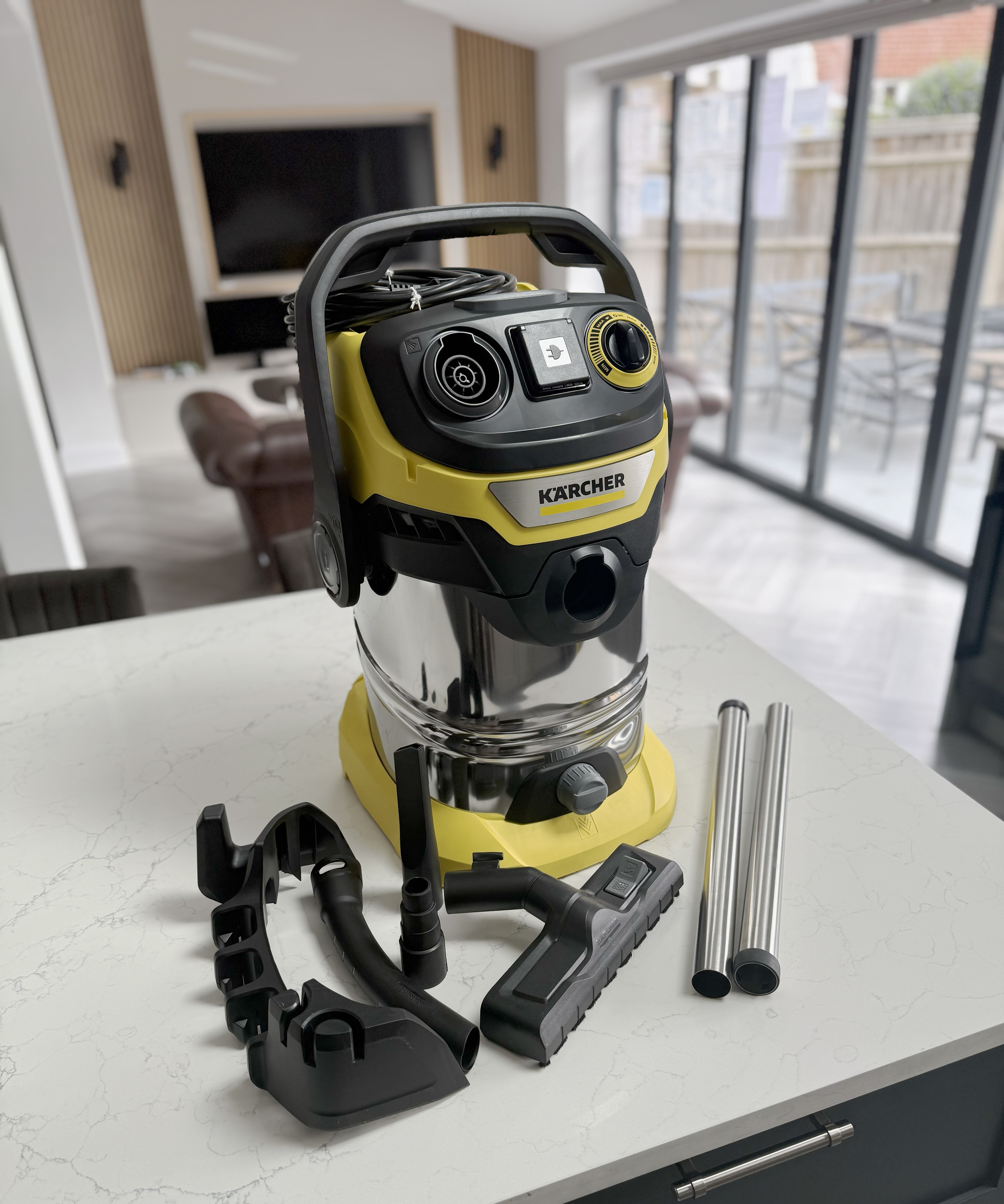 K&amp;auml;rcher WD 6 wet and dry vacuum cleaner with accessories, tubes and floor head laid out on a kitchen island