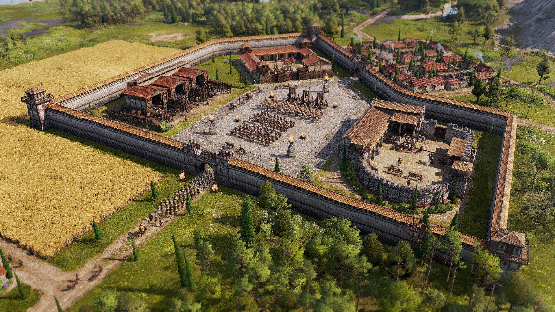 A bird's-eye view of an ancient Roman-style fortress with stone walls, a central courtyard filled with soldiers' formations, surrounded by lush fields and trees.