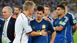 Bastian Schweinsteiger of Germany consoles Lionel Messi of Argentina after Germany's 1-0 victory in extra time during the 2014 FIFA World Cup Brazil Final match between Germany and Argentina at Maracana on July 13, 2014 in Rio de Janeiro, Brazil.