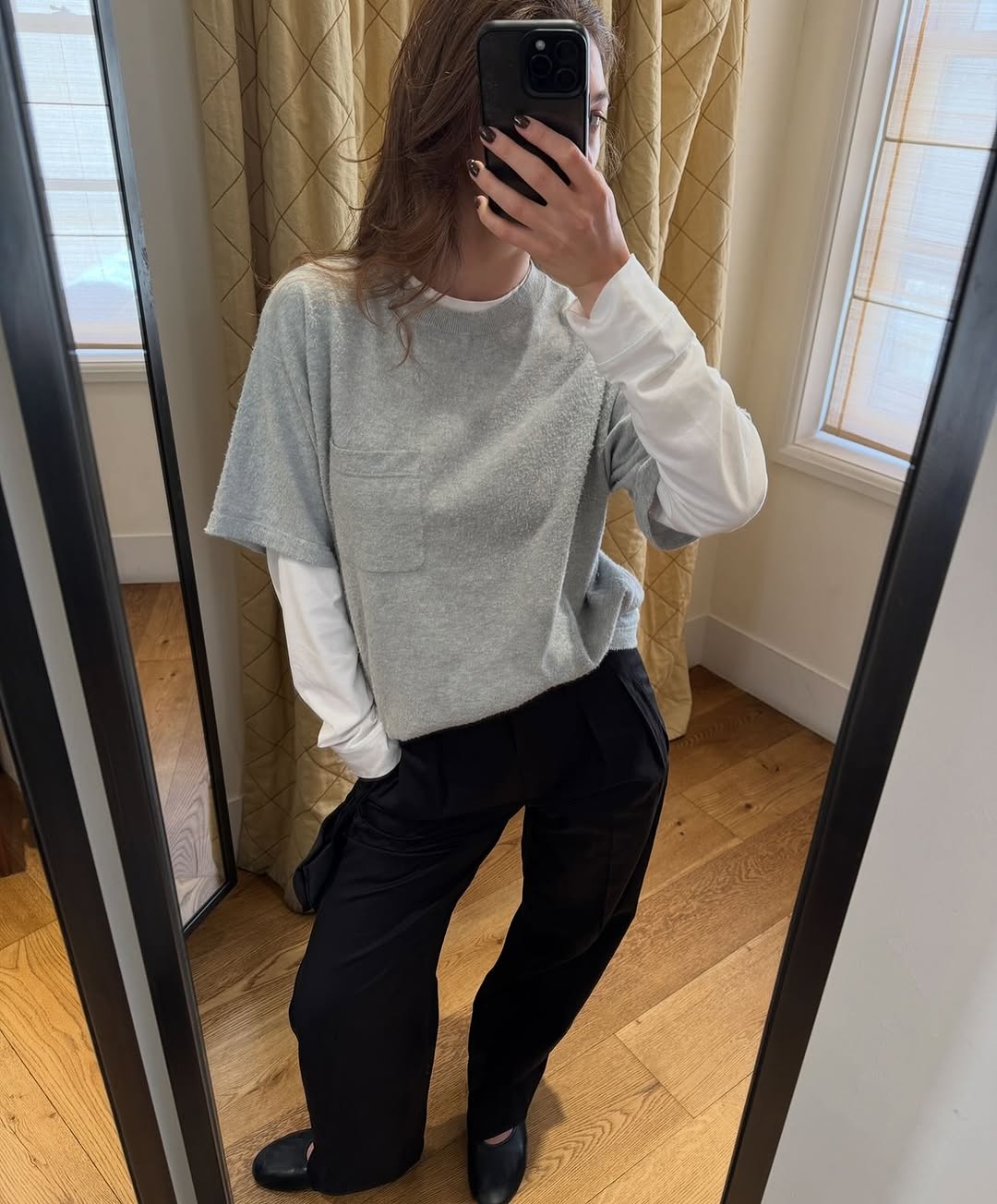 Woman wearing a gray T-shirt outfit.