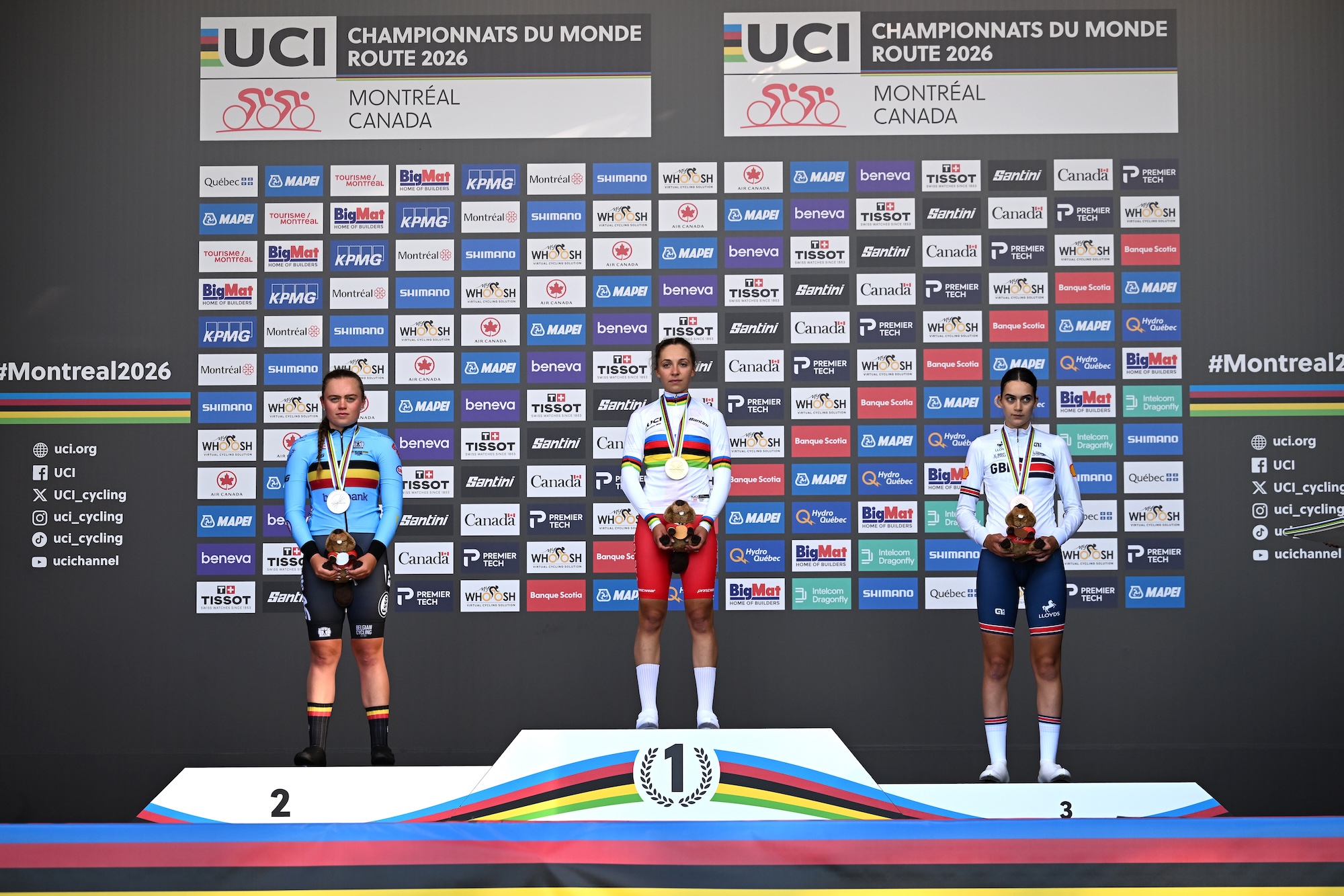 Silver medalist Yana Decruyenaere and Team Belgium, gold medalist Maria Okrucinska and Team Poland and bronze medalist Aalia Clay and Team Great Britain pose on the podium during the medal ceremony after the 99th UCI Road World Championships Montreal 2026.