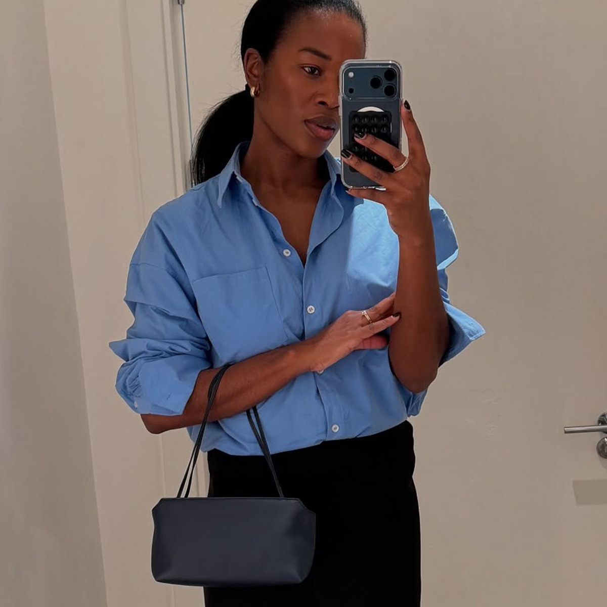 @nlmarilyn wearing a blue button-down shirt from COS.