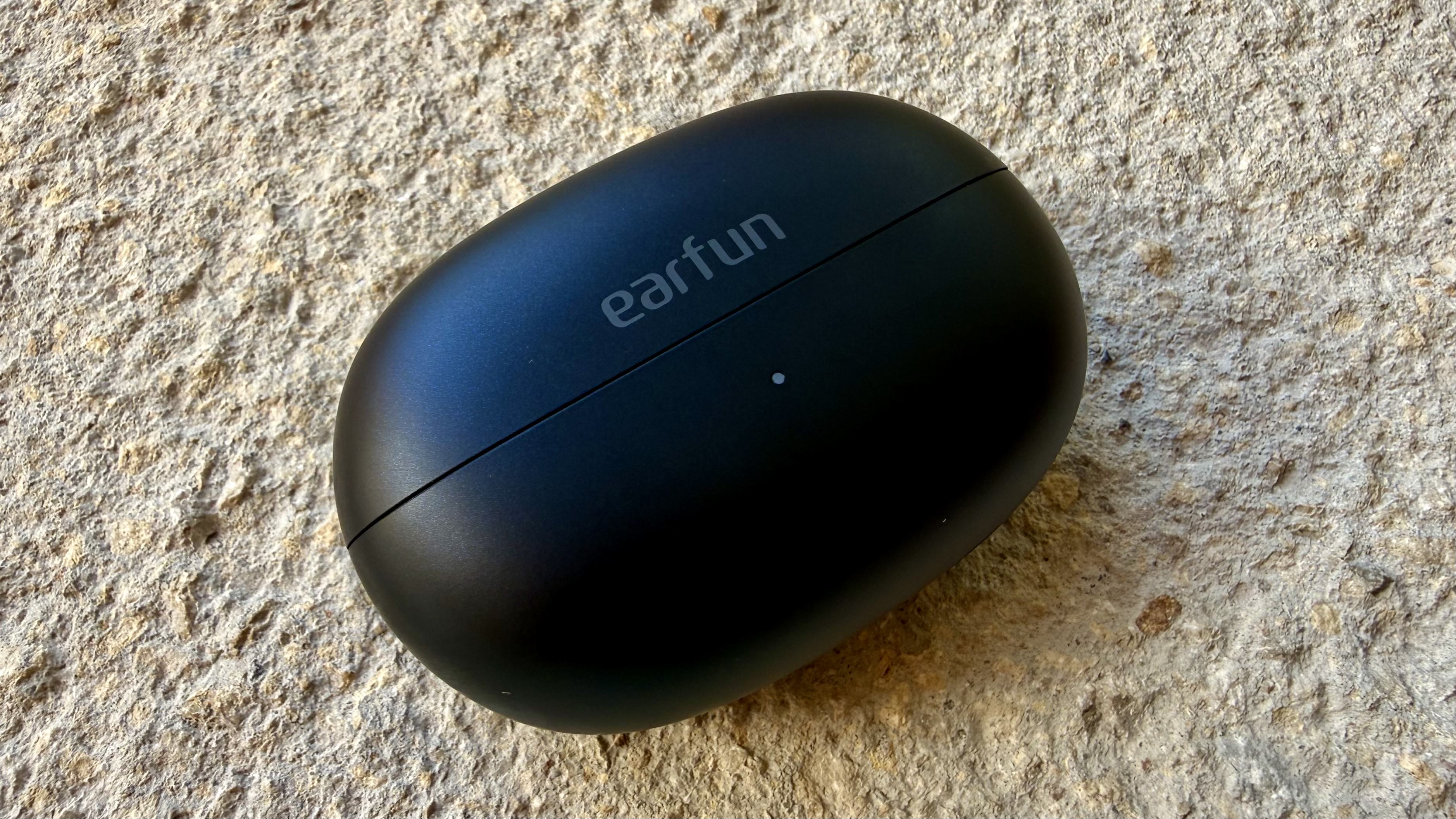 The EarFun Clip 2 buds in their closed charging case