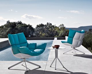 B&B Italia outdoor furniture with teal cushions by a pool