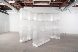 Art exhibition space featuring transparent floor kitchen units and hanging wall units made from PET plastic