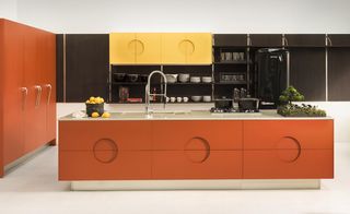 A view of a brightly coloured orange kitchen
