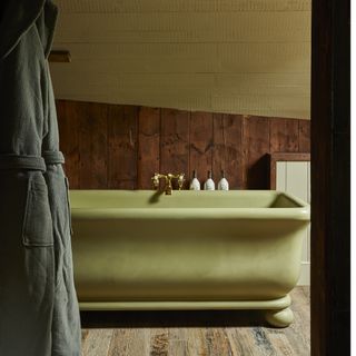 Green avocado bathroom with rustic walls and floors