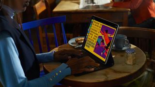 Product shot of someone using one of the best iPad Pro cases on a table in a cafe